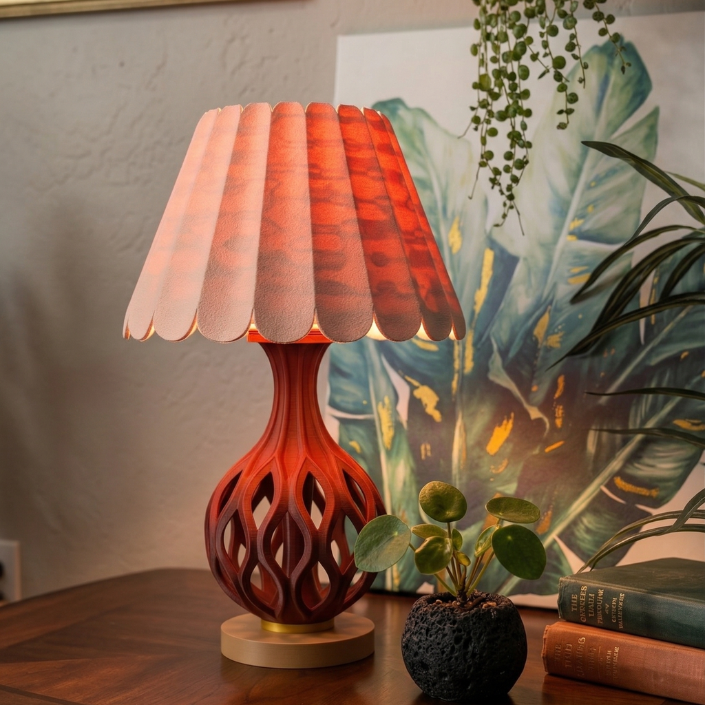 Decorative table lamp with a unique design on a wooden surface, surrounded by plants and books.